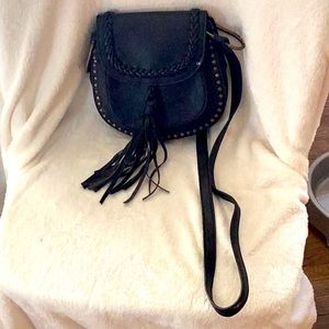 This is a leather bag with gold dots.